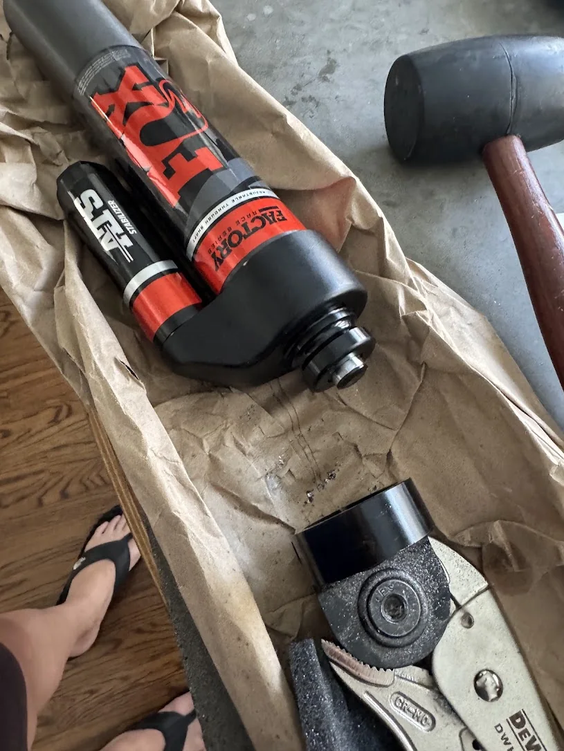 FOX ATS stabilizer on the bench with the clamp held in locking pliers and a rubber mallet beside it.